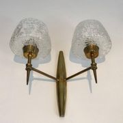 Pair of bronze wall sconces with worked glass reflectors. Stilnovo