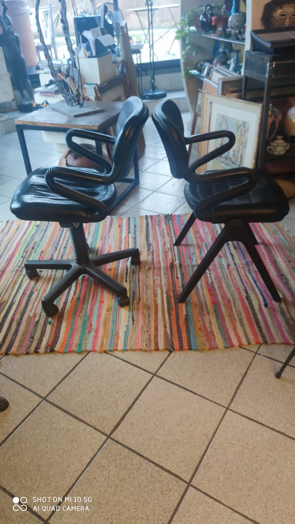 Two black leather armchairs