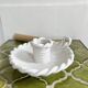 Hand-held candle holder with braided ceramic bowl