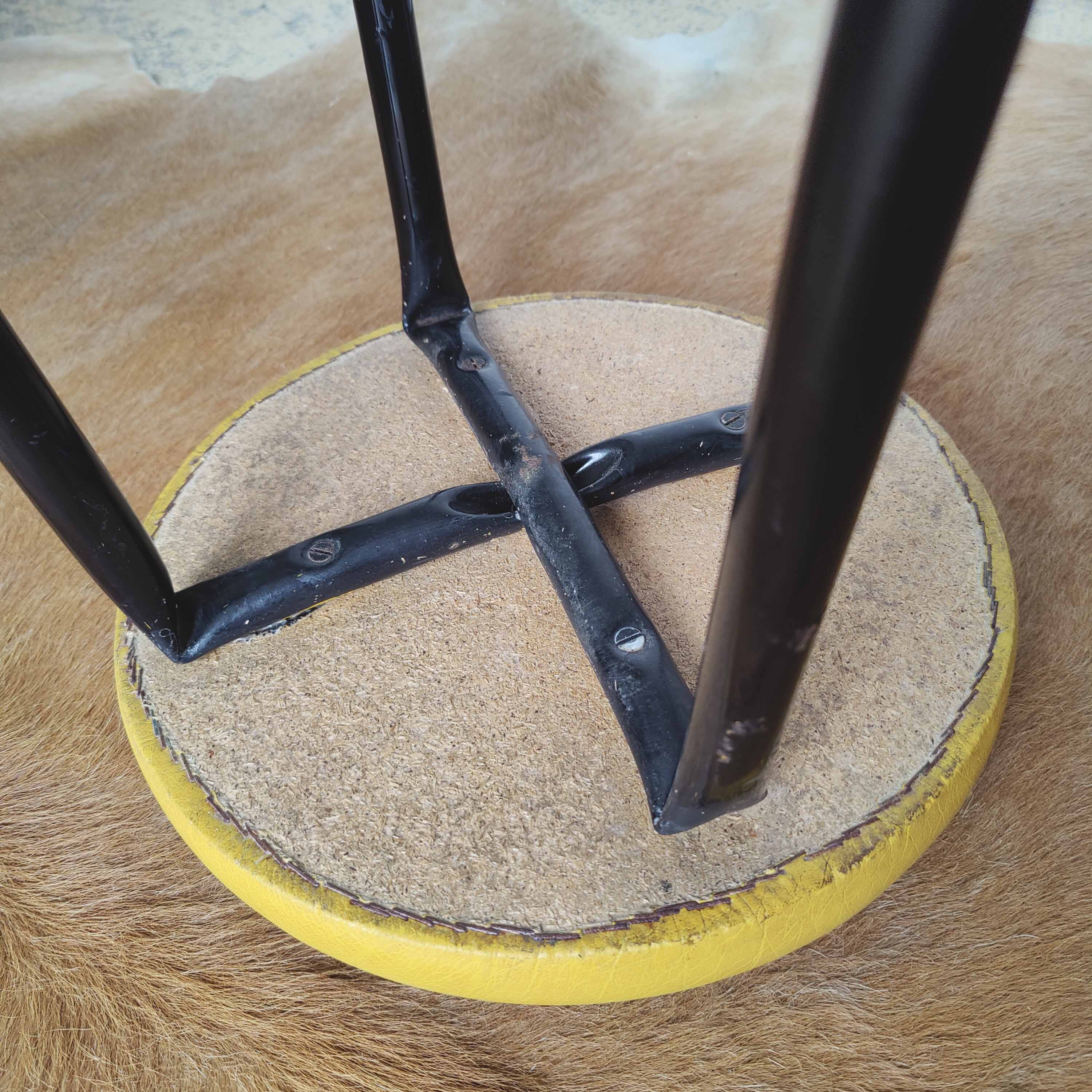 Pair of black metal bar stools and yellow imitation leather seat