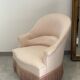 Pink armchair with patterns and fringes.