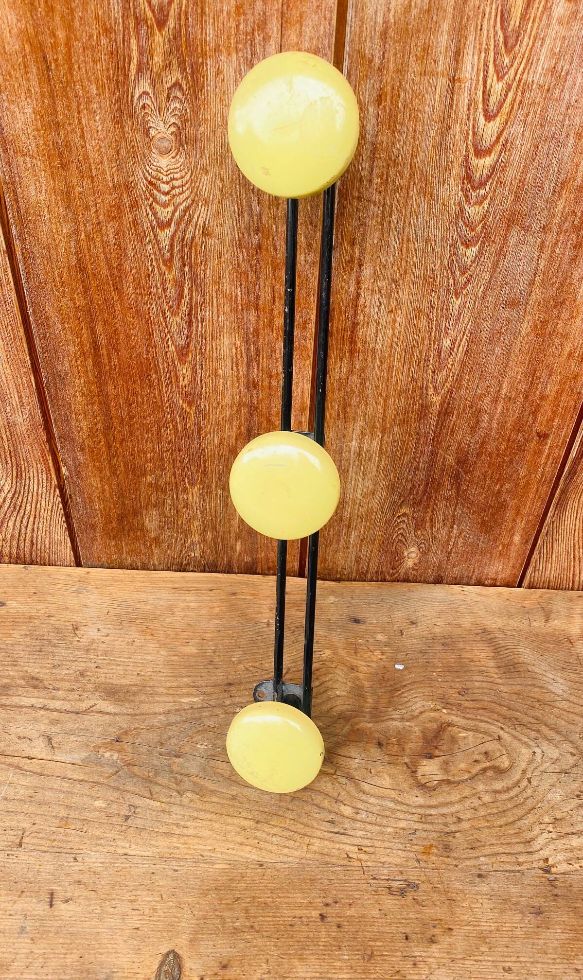 Vintage yellow metal wall coat rack