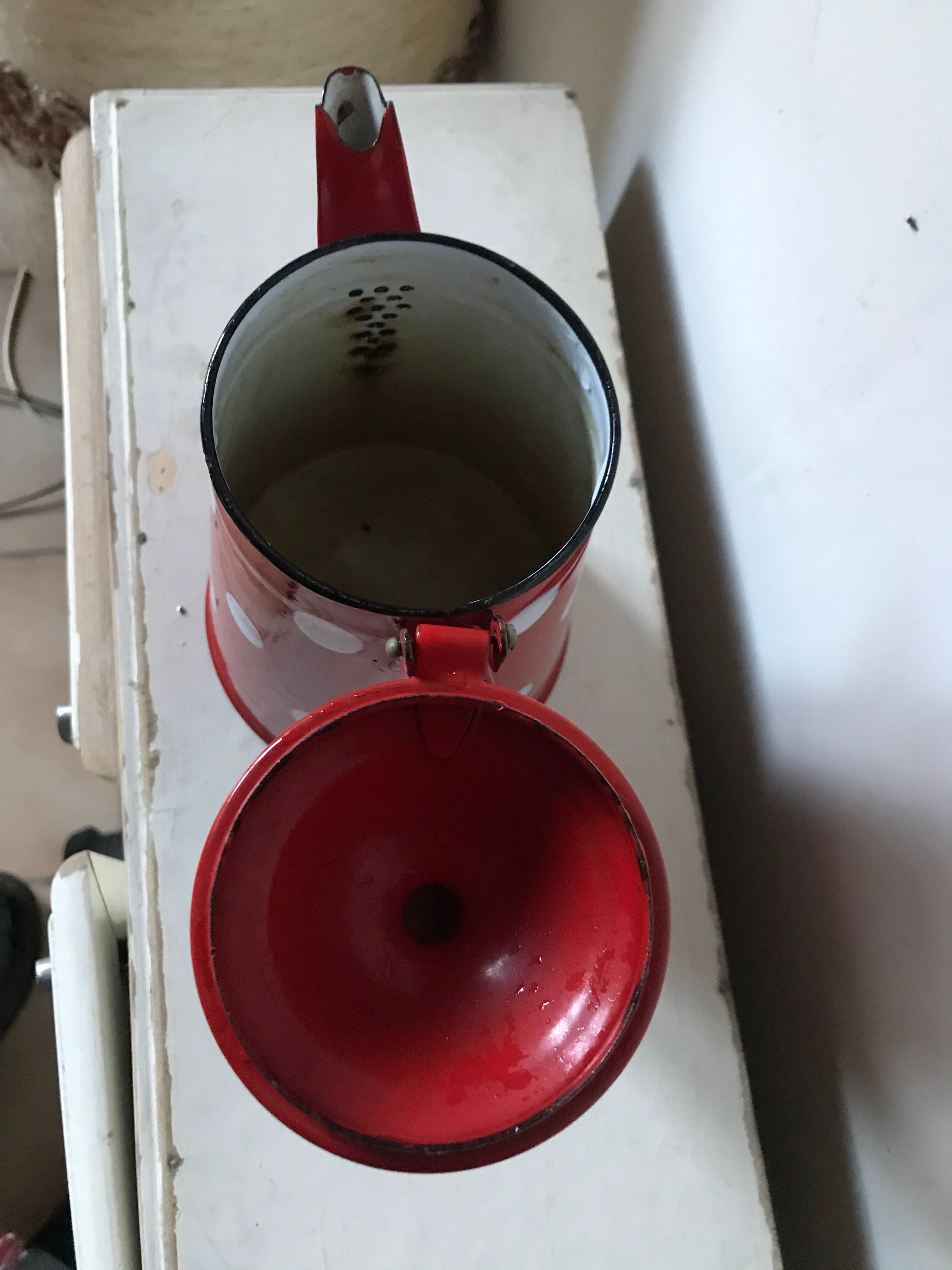 Red enamelled coffee maker with white polka dots