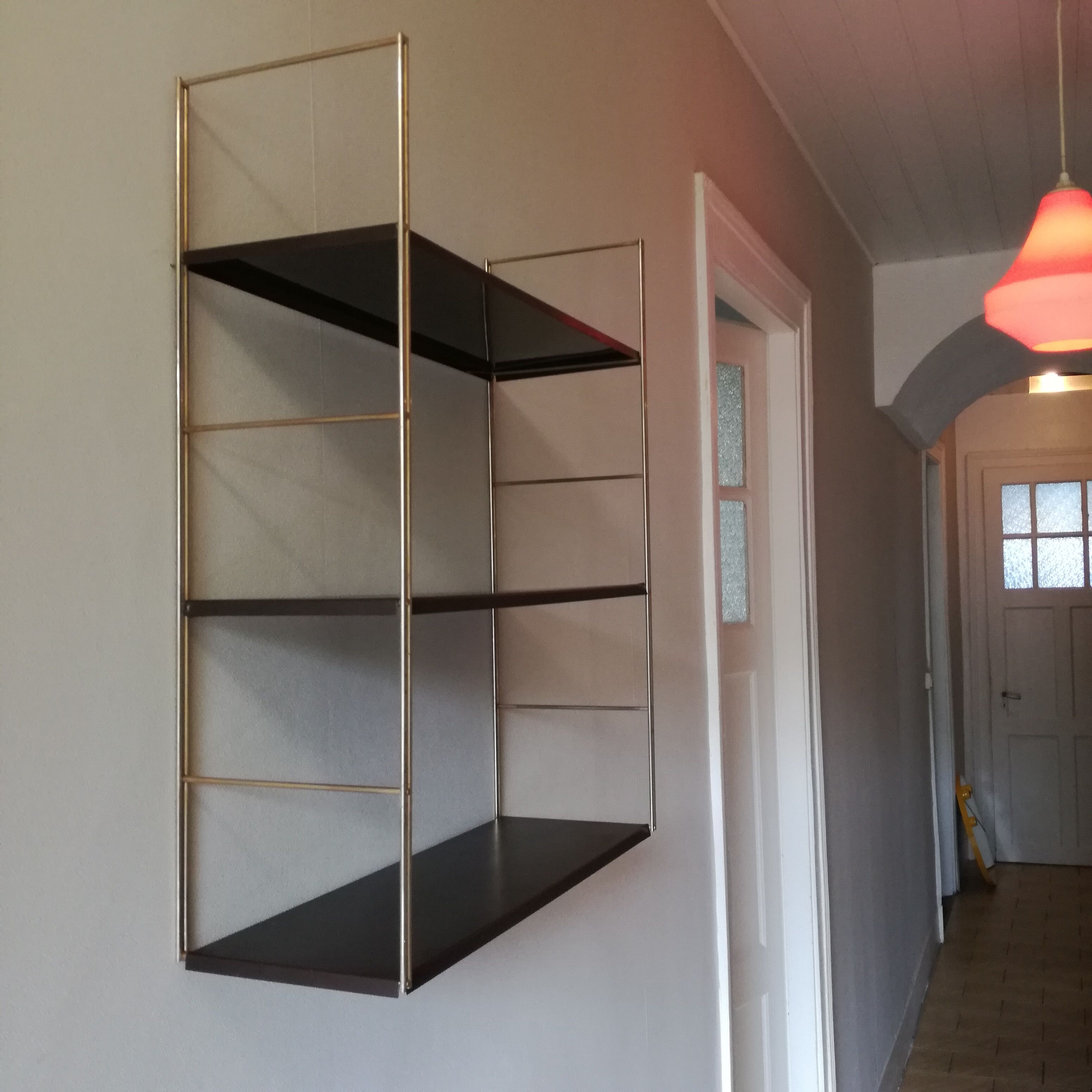 Golden and brown stringed shelf in metal