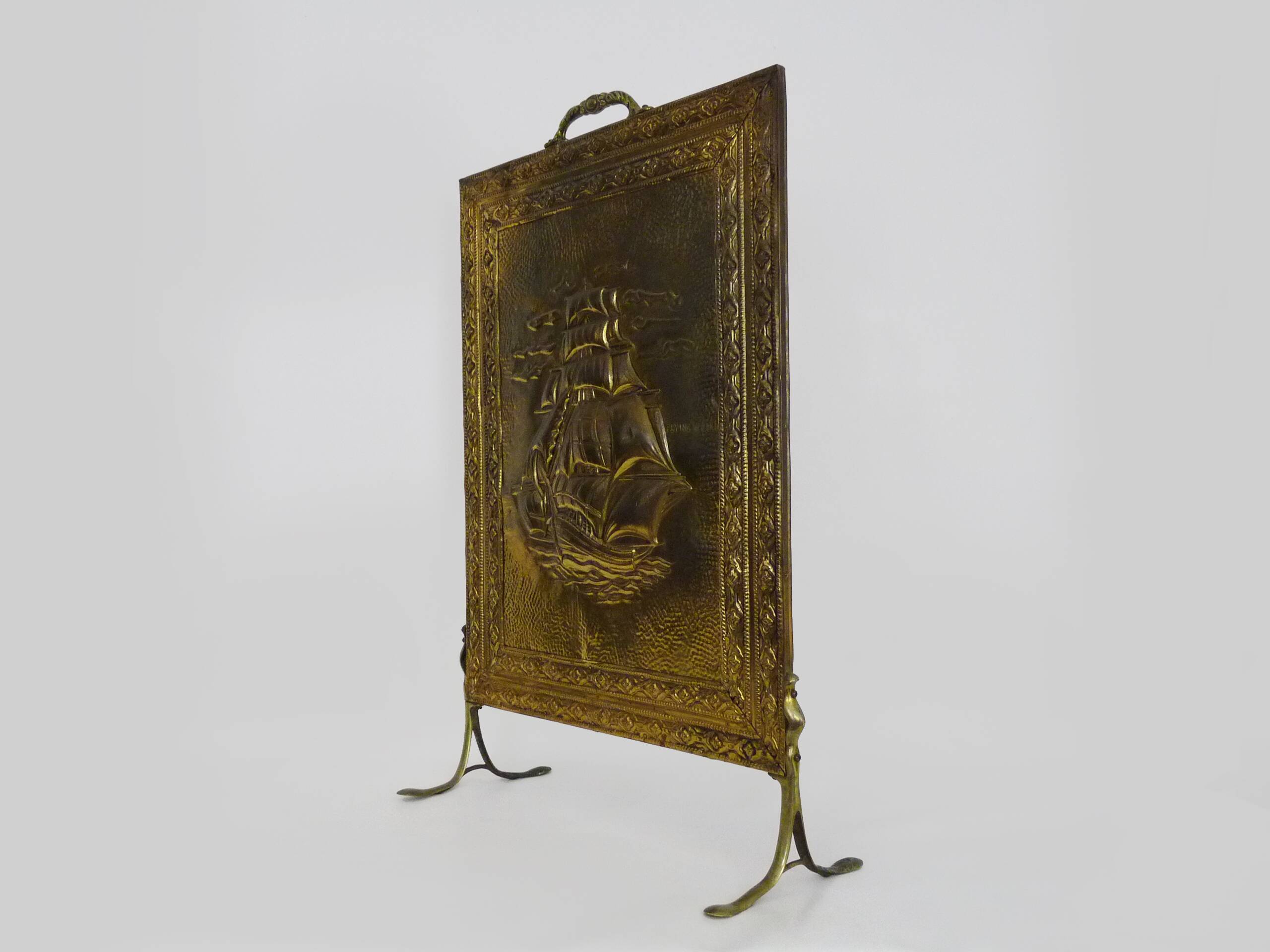 Fireplace screen in repoussé brass with a sailing boat. 1960s.