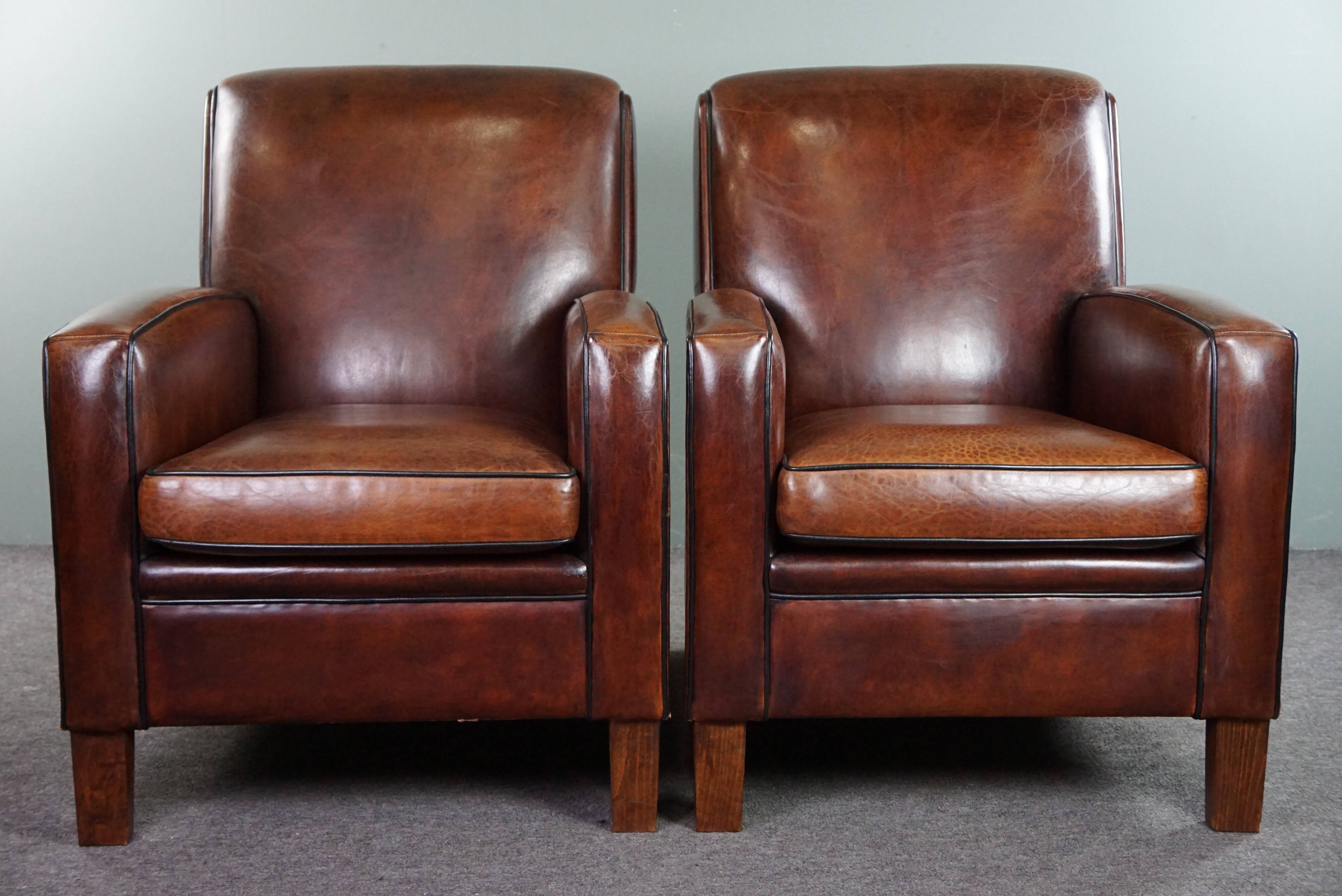 A very beautiful set of 2 Art Deco design armchairs in sheep leather