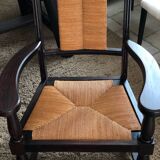 Pair of vintage 1950s Neo-Basque oak armchairs with straw seats and backs.