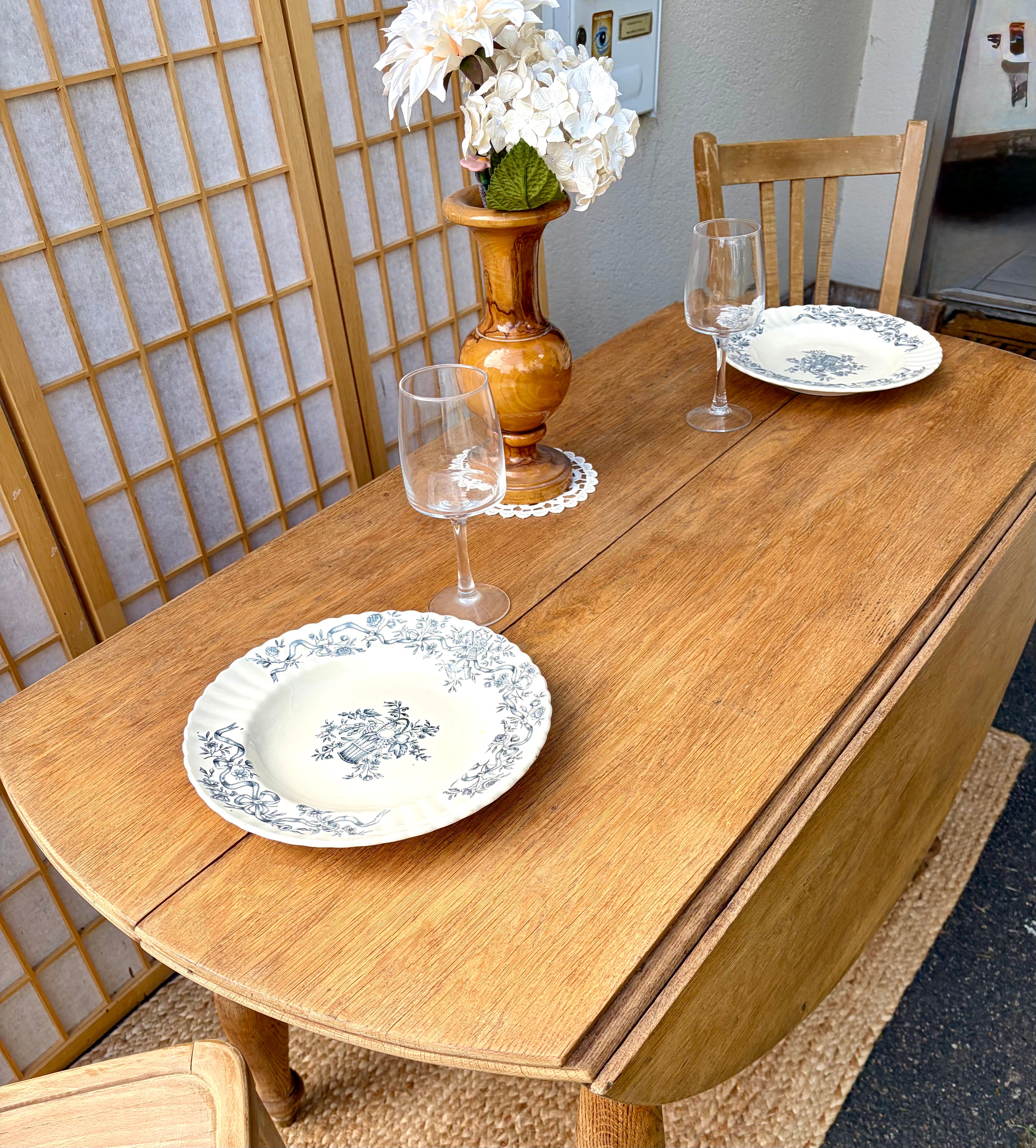 Round oak table with a drop leaf.