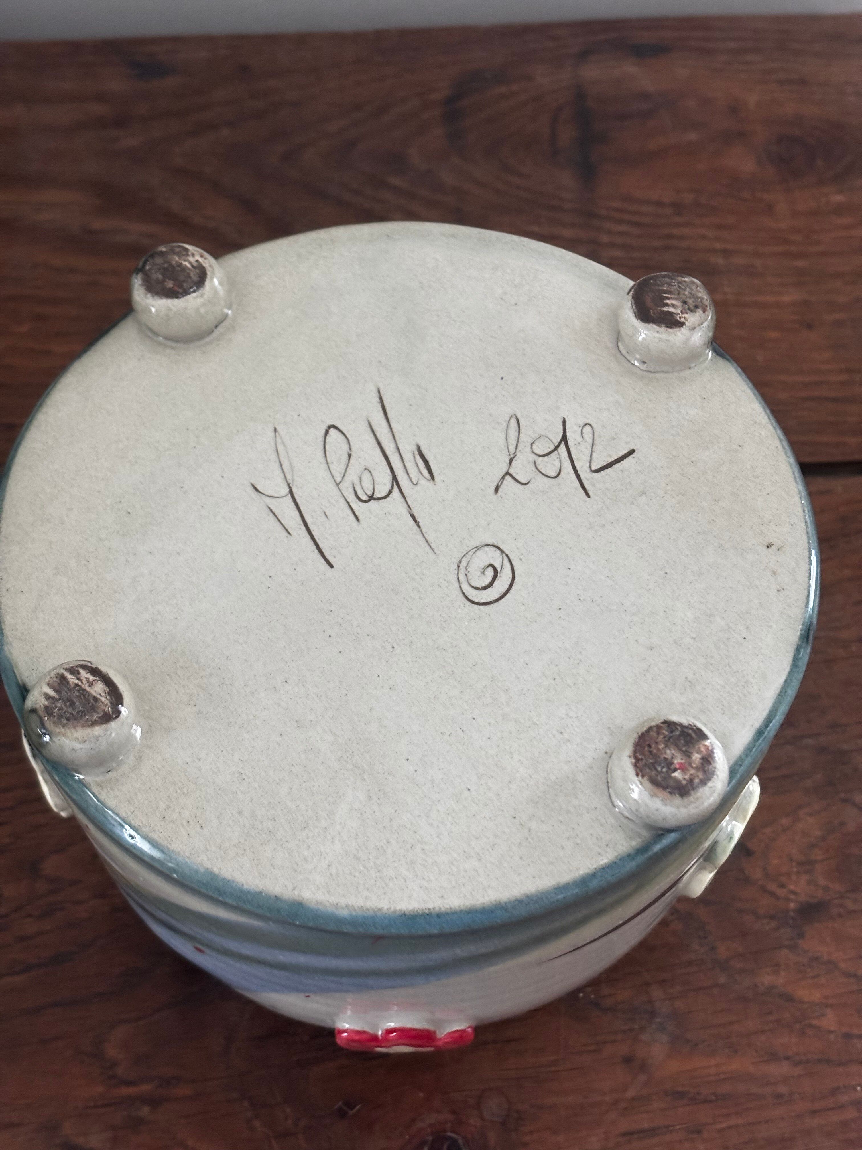 Superb handcrafted pottery pot with relief flowers signed on the back.