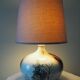 Glazed ceramic ball lamp signed Bossis with a fabric shade.