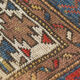 Handwoven blue ground persian rug with bird-like figures