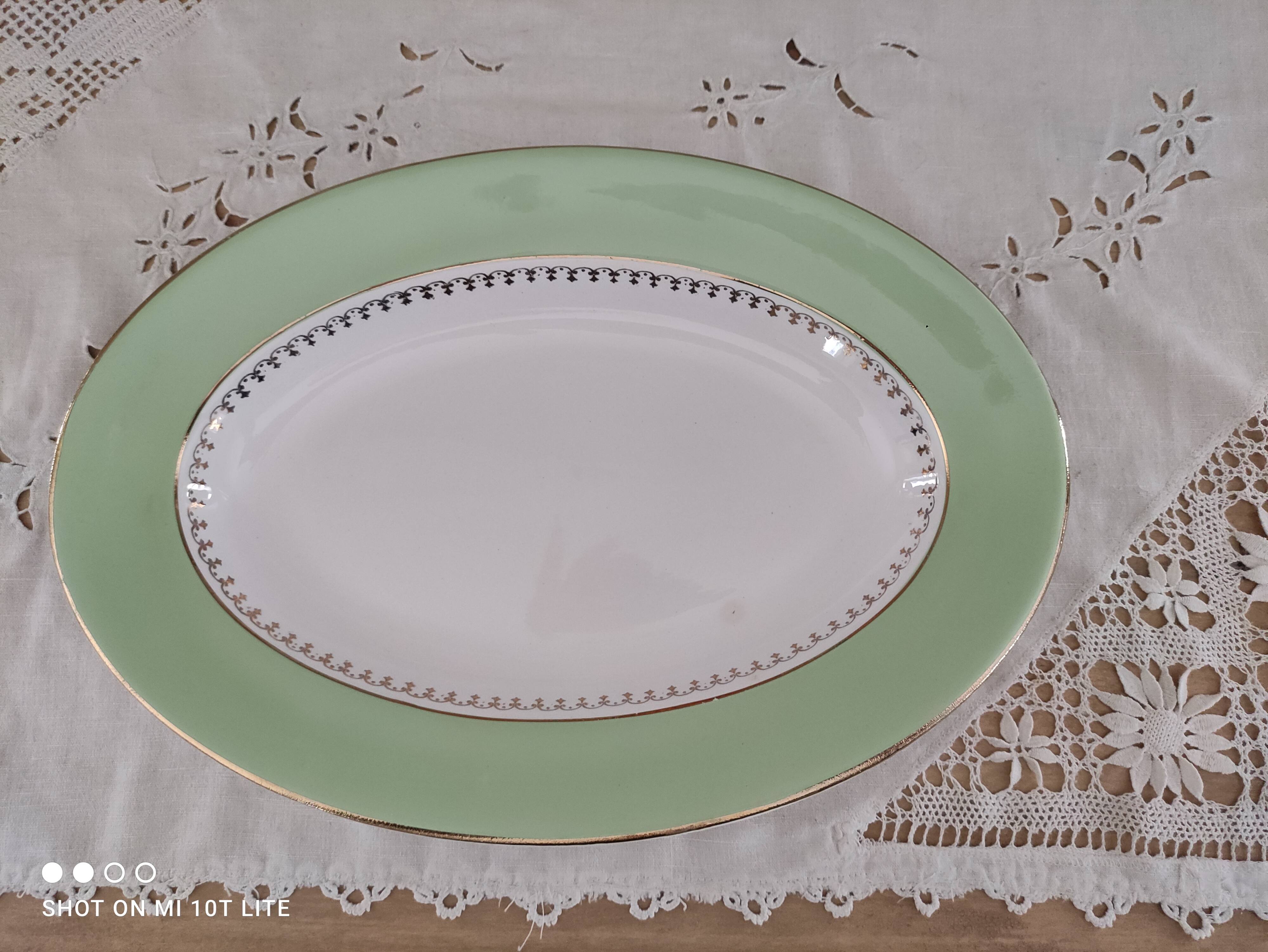 Oval plate with a light green rim and golden frieze, Cafés Lemaire.