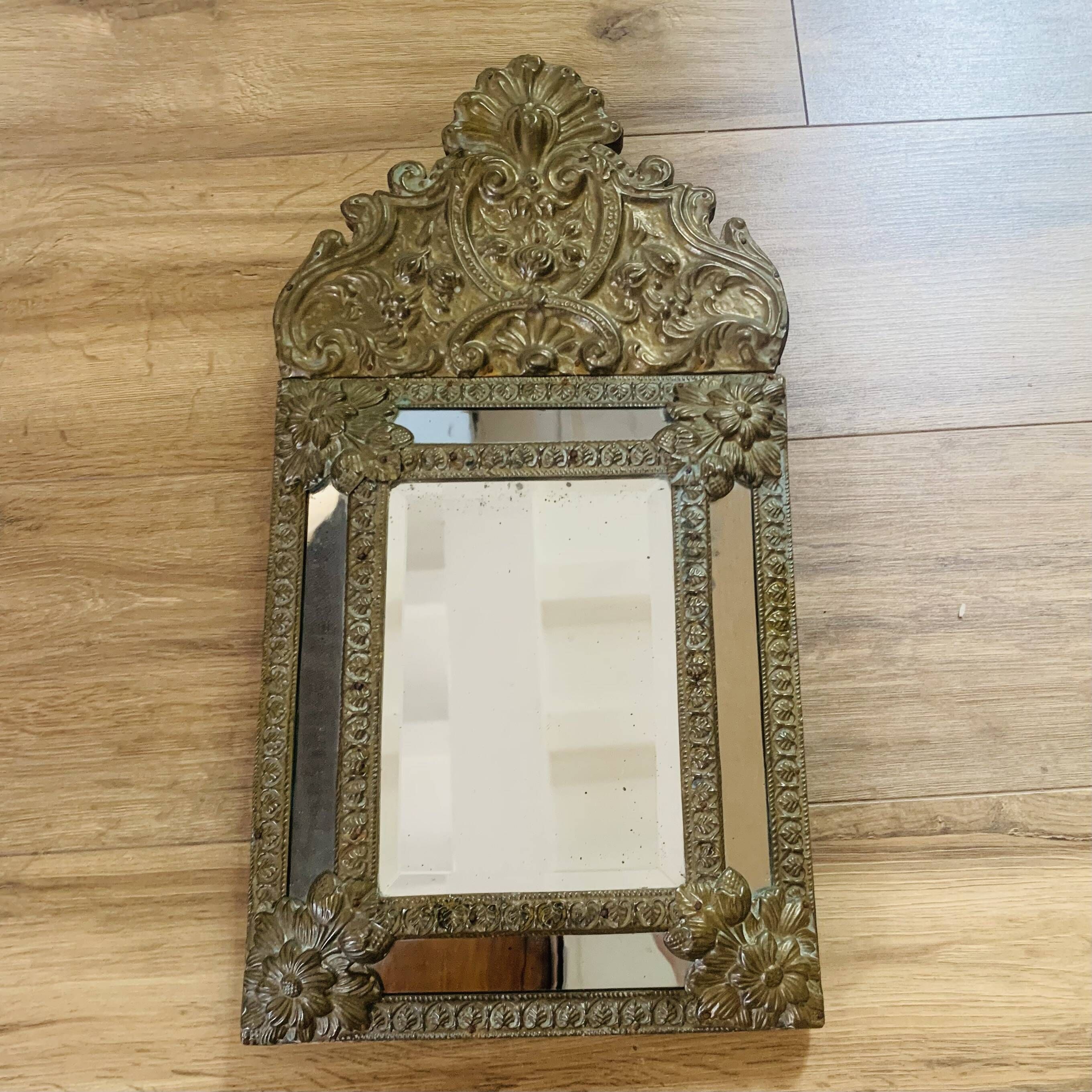 Small mirror with repoussé brass frame.