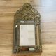 Small mirror with repoussé brass frame.