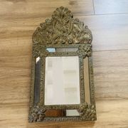 Small mirror with repoussé brass frame.