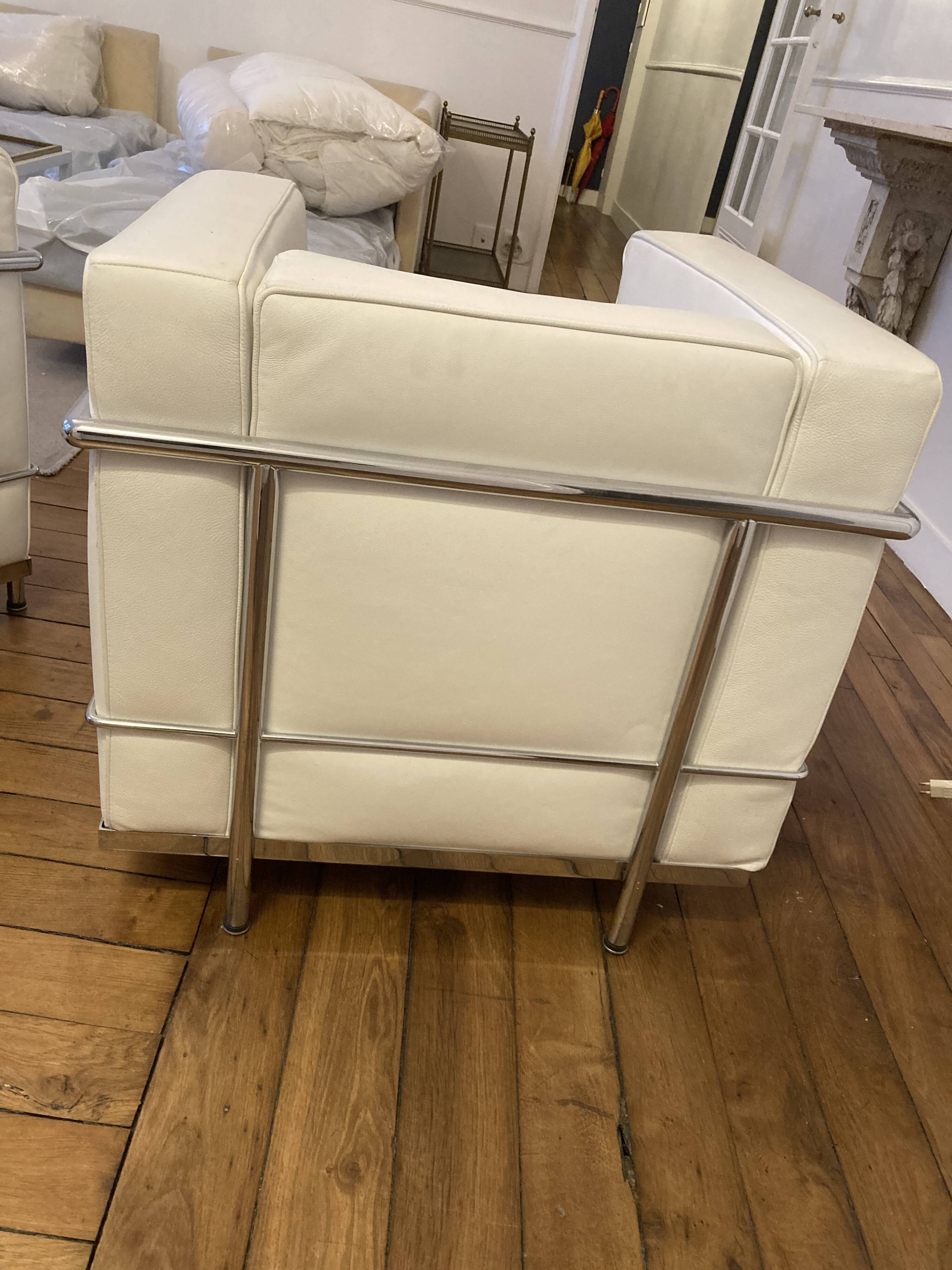 Pair of white leather and chrome armchairs