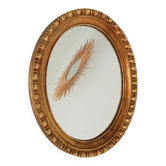 Vintage Italian oval mirror in gilded wood.