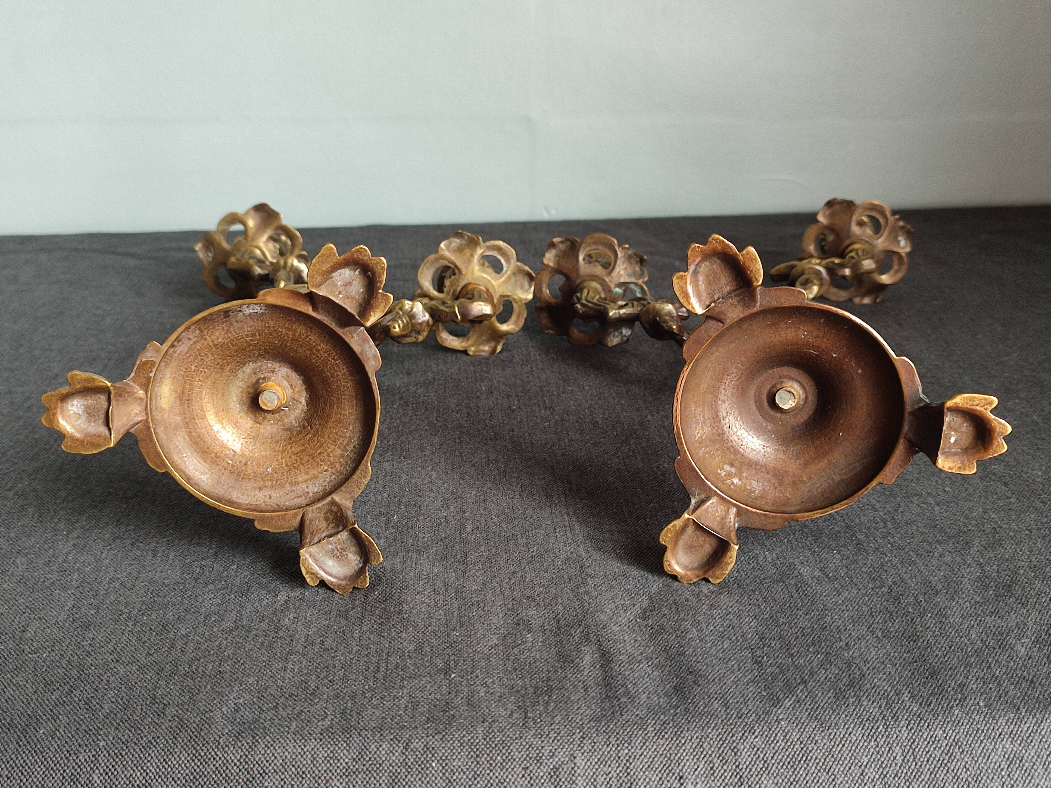 Pair of antique candlesticks in cherub bronze