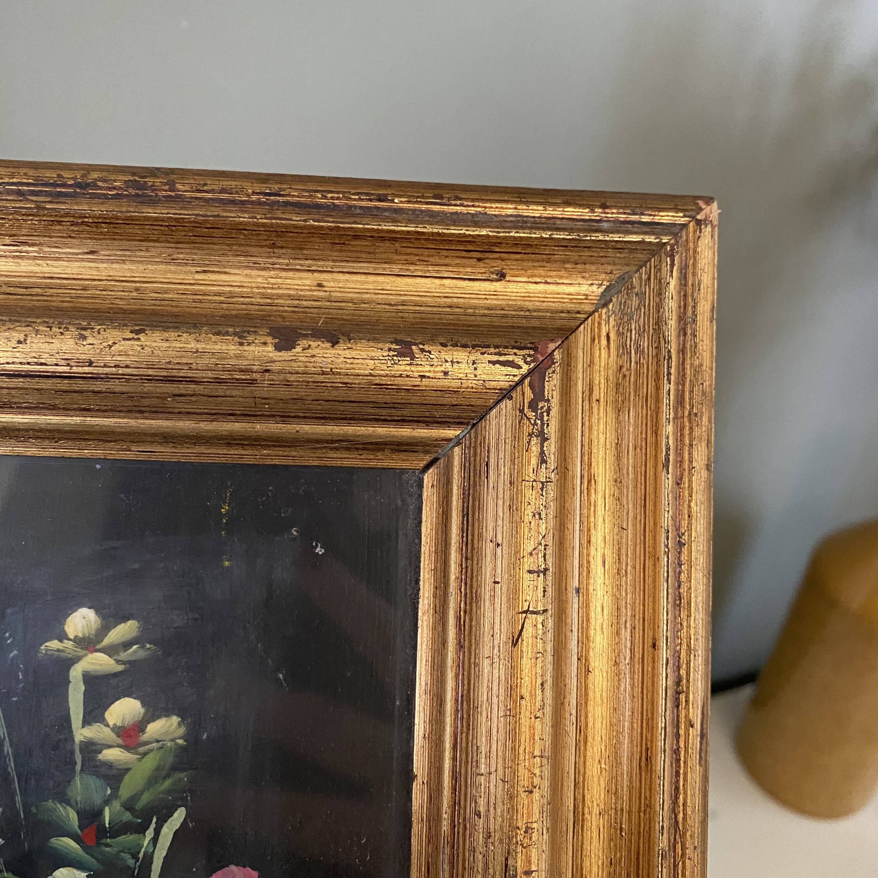 Golden frame with painting bouquet of flowers