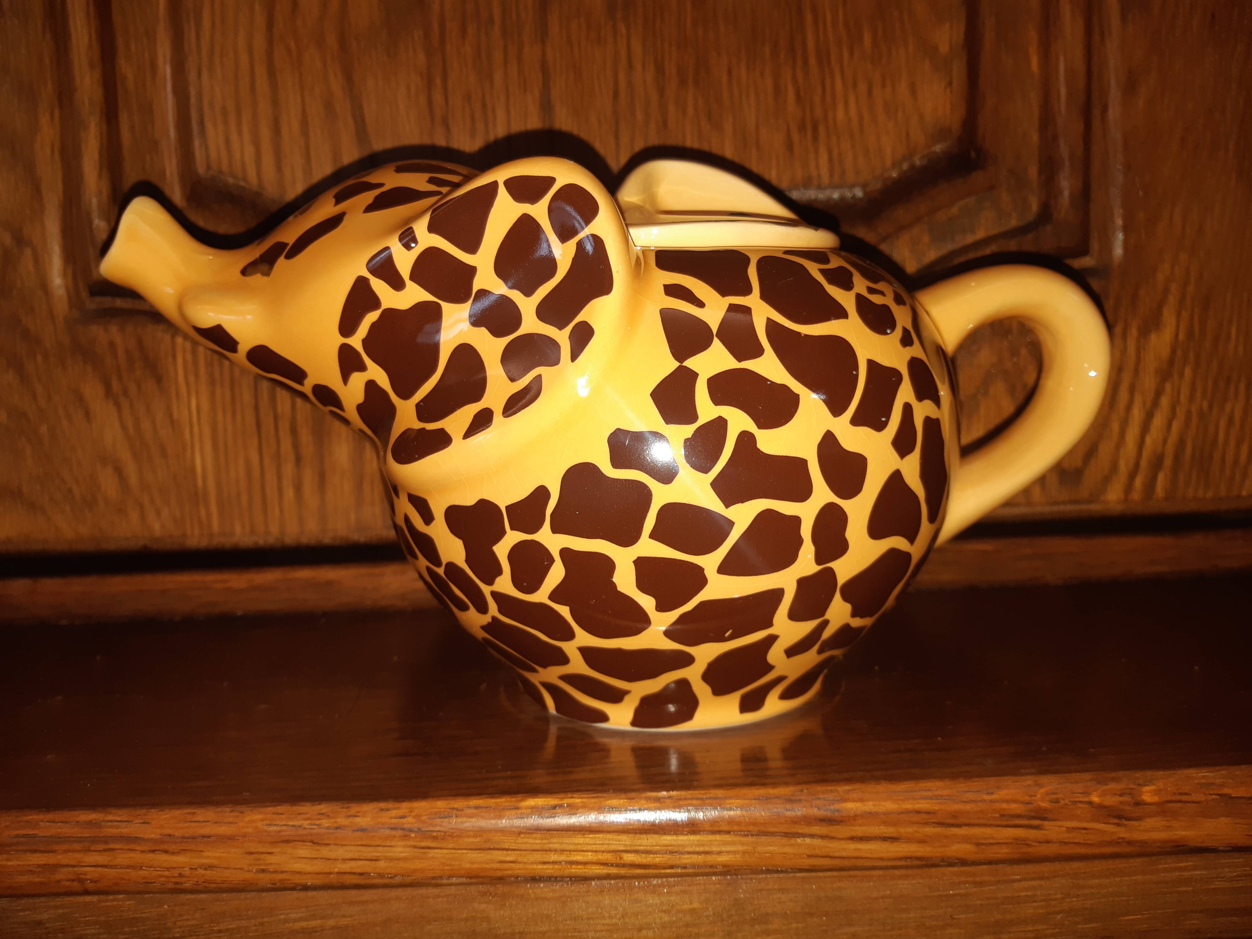 Elephant teapot decorated with giraffe cheetah, signed by the brand elephant 1896