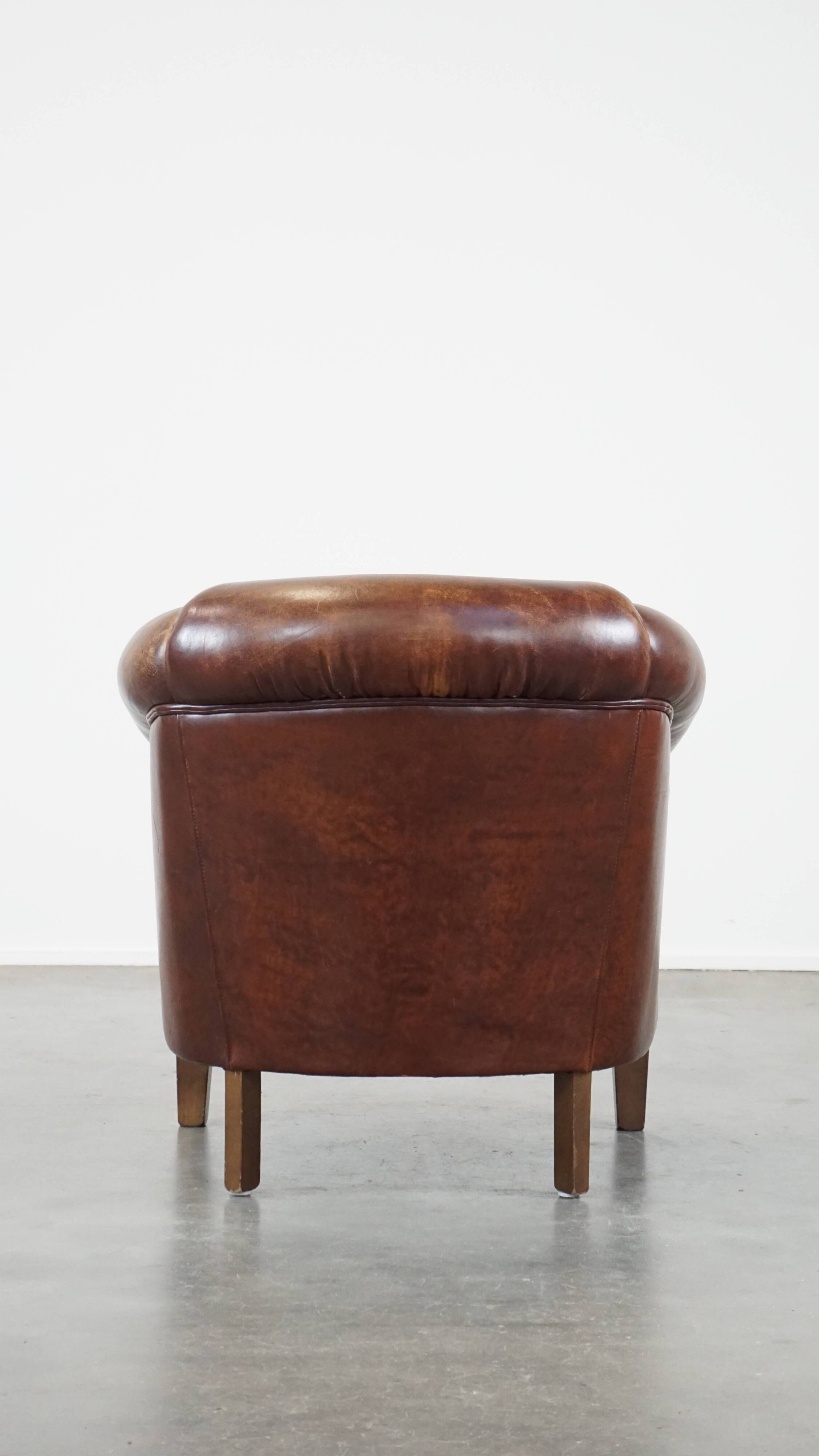 Sheepskin club armchair, correct finishing with decorative nails