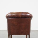 Sheepskin club armchair, correct finishing with decorative nails
