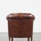 Sheepskin club armchair, correct finishing with decorative nails