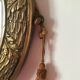 Golden oval mirror with its wooden frame and stucco on wood, nicely cracked by time