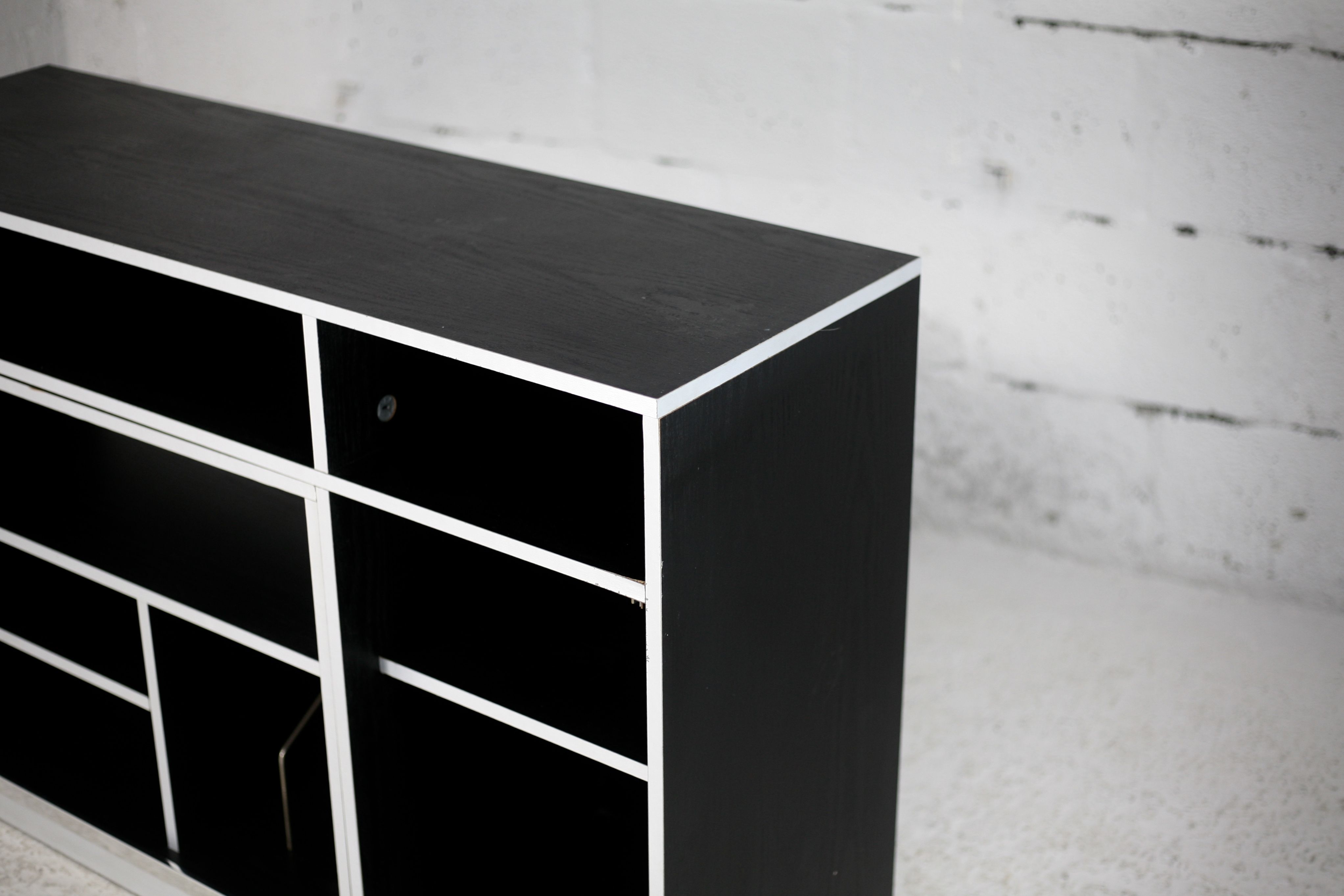 Storage cabinet wood compressed lacquered black lining margins aluminum. France, circa 1975.