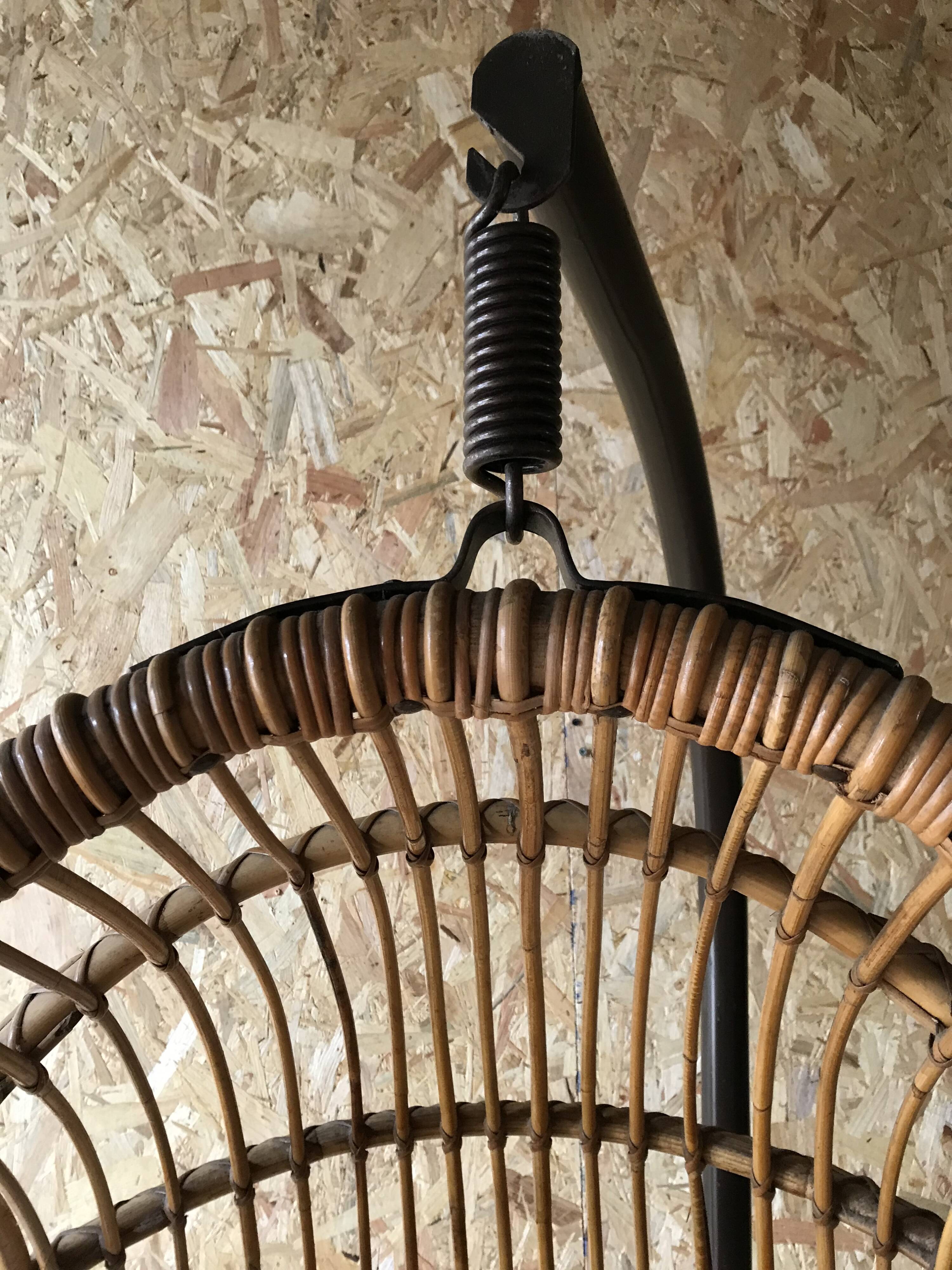 Vintage rattan hanging chair with its stand.