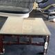 Vintage brutalist coffee table with Asian decor.