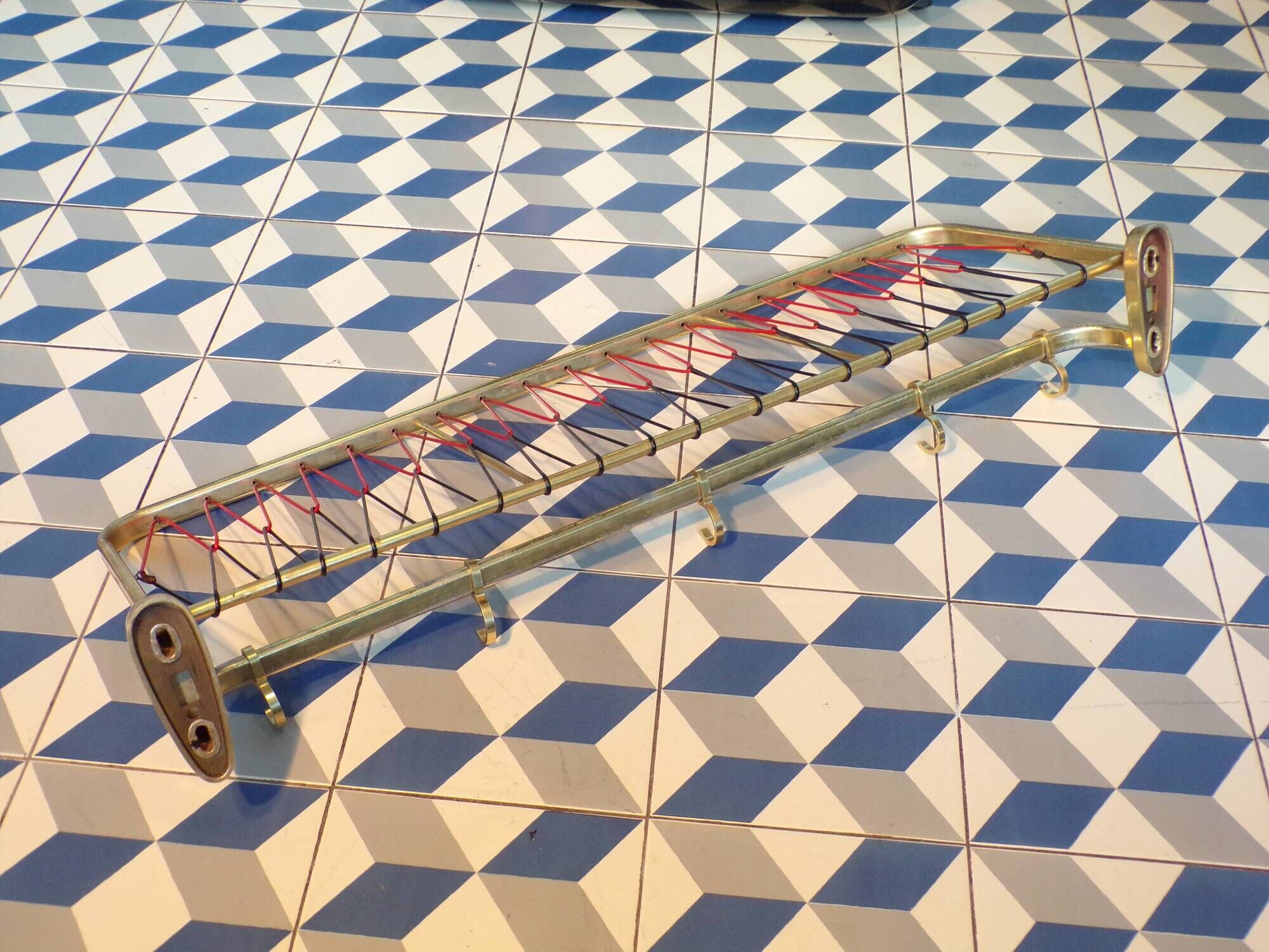 Coat rack styled like a train luggage rack, length = 81 cm.