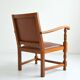 Antique brutalist oak and vinyl armchair
