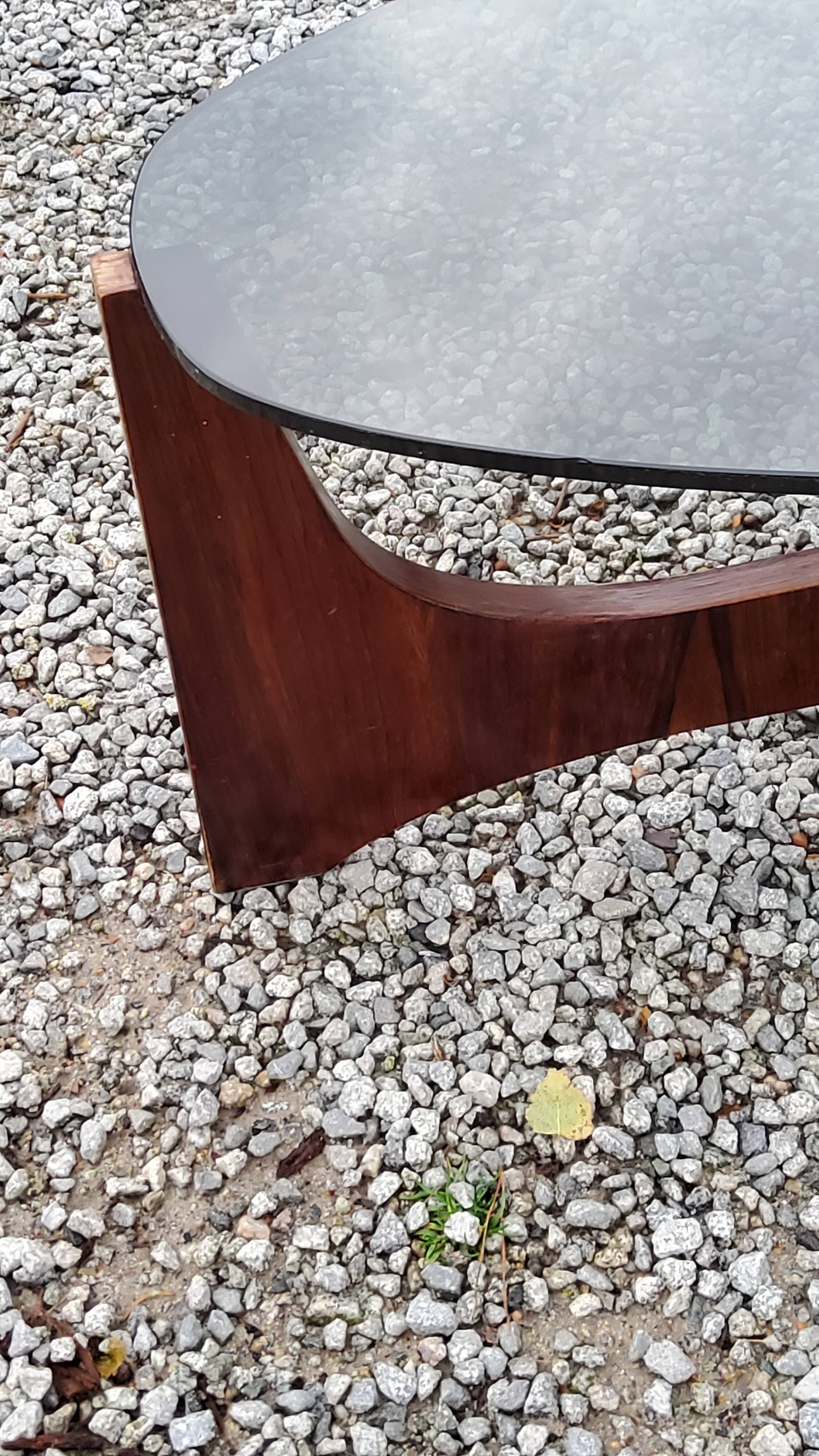 Designer coffee table by Hugues Poignant in rosewood and smoked glass from the 70s