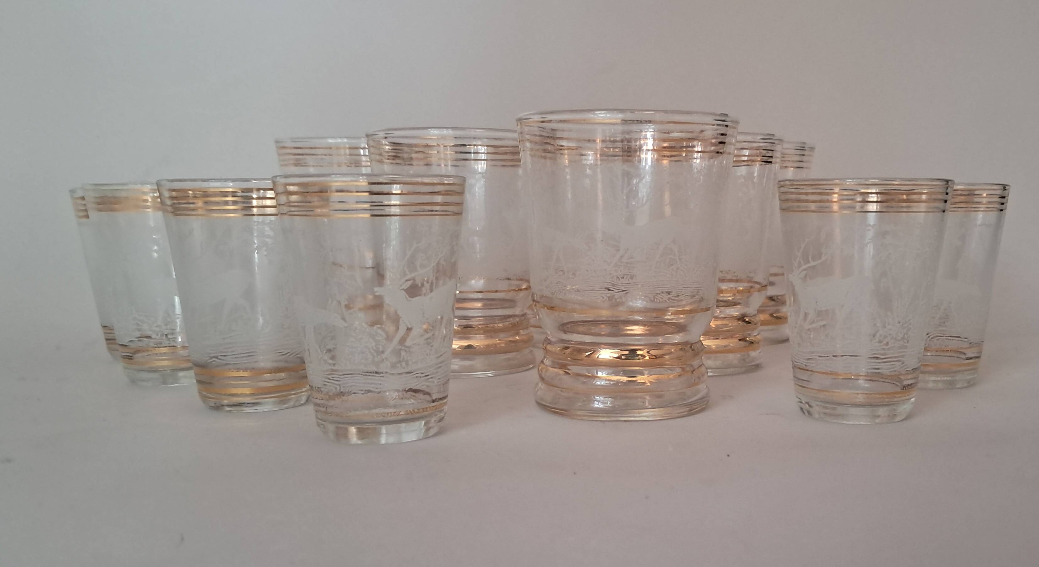 Service of 14 gold-plated and engraved glasses with a deer in the woods design from 1950
