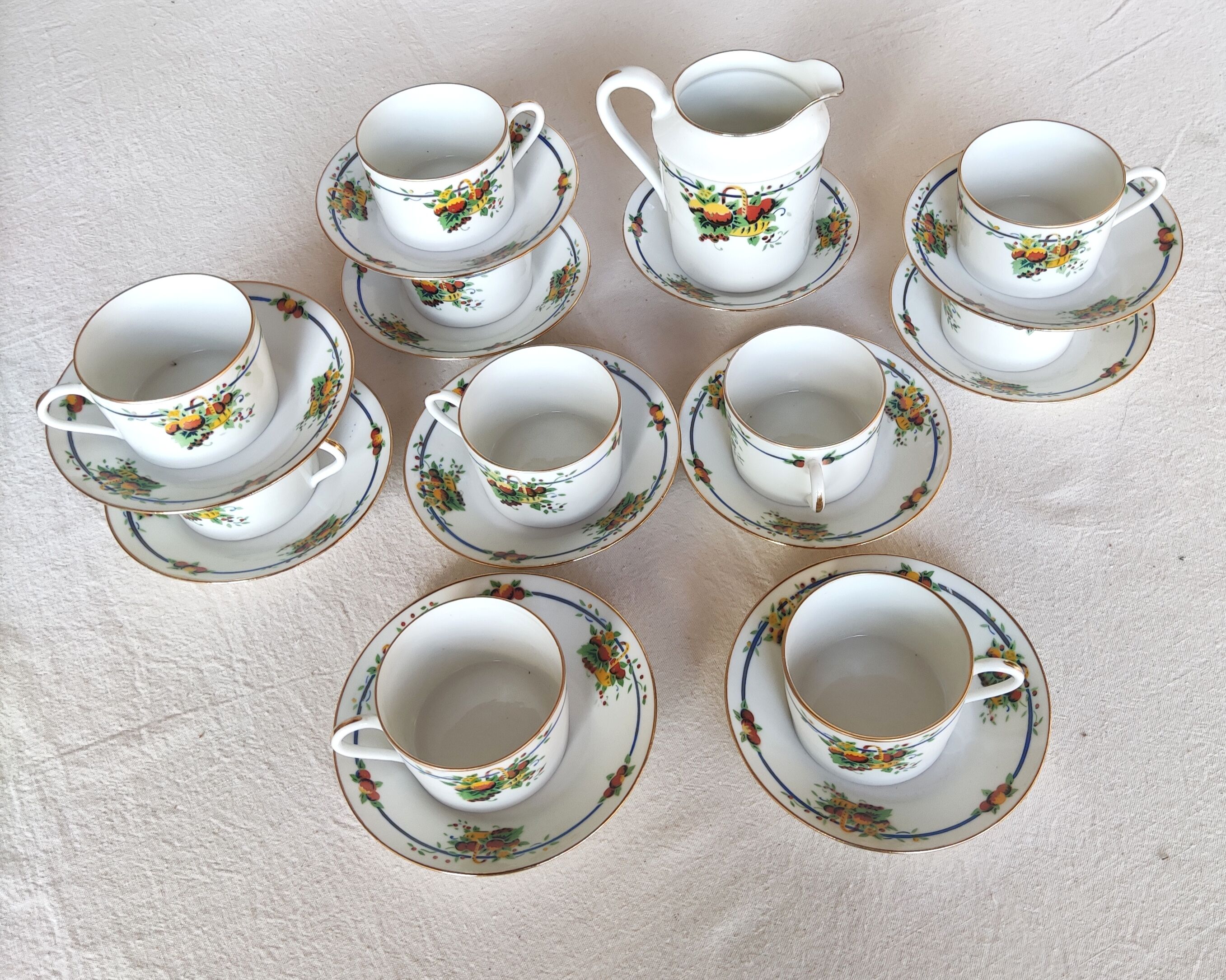 10 tea cups and creamer in Limoges porcelain