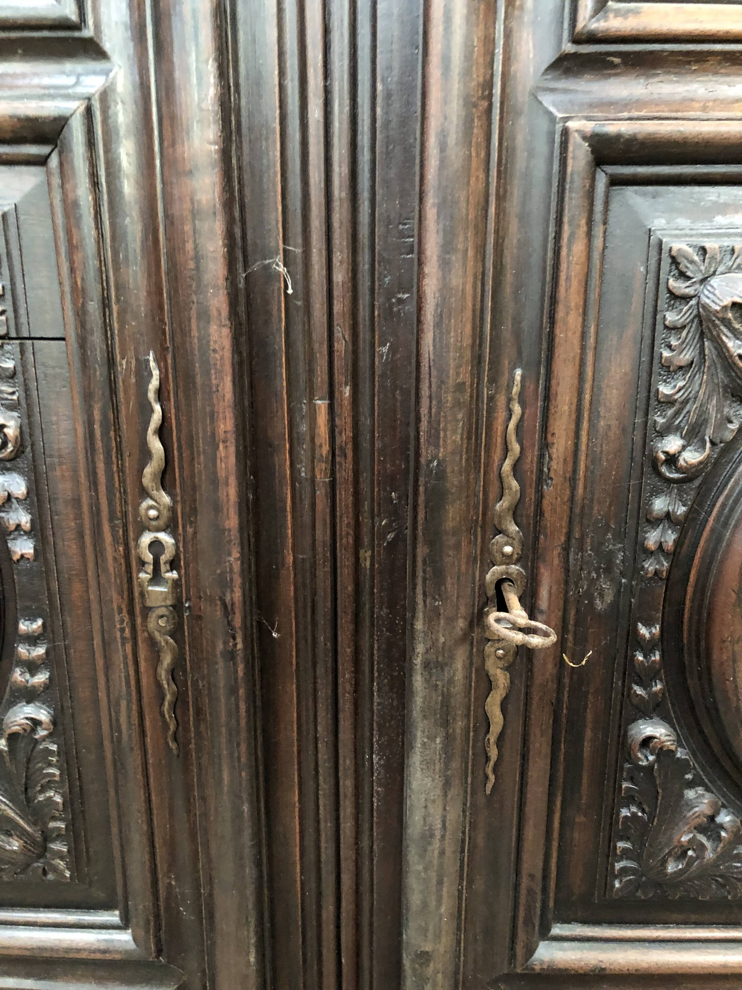 Antique Louis XIII armoire in solid walnut with carved doors