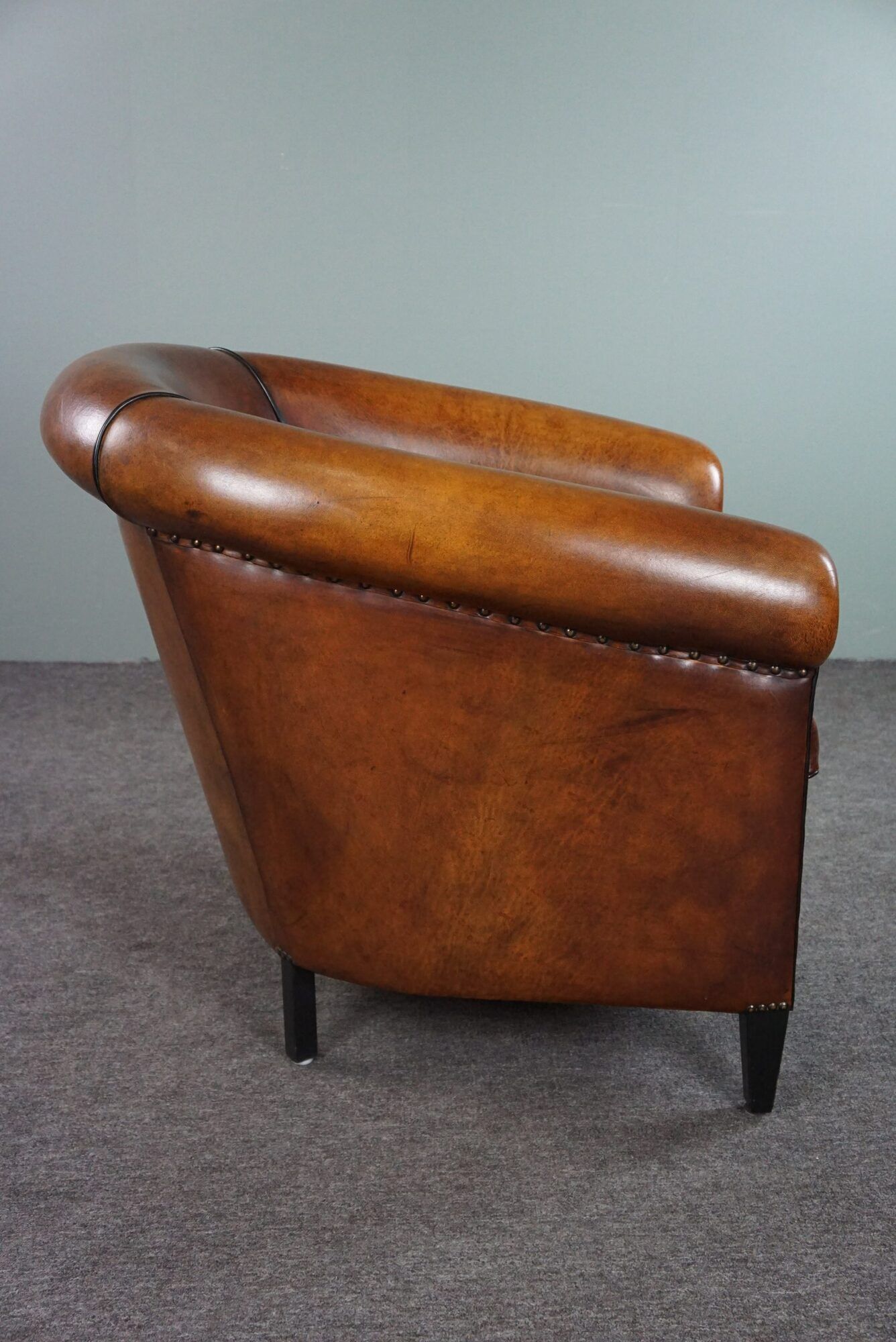 Club armchair in sheepskin with black piping