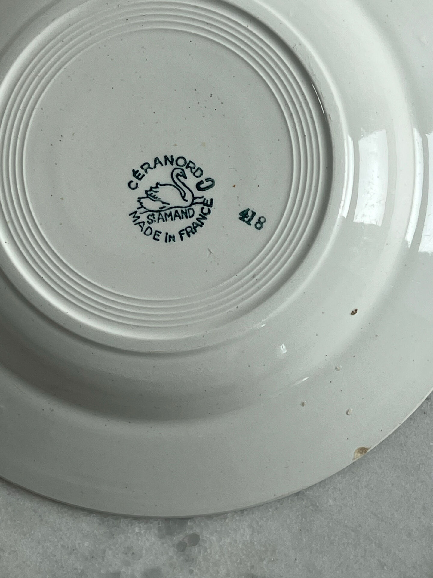 Céranord Saint Amand deep plate with green crown decoration.