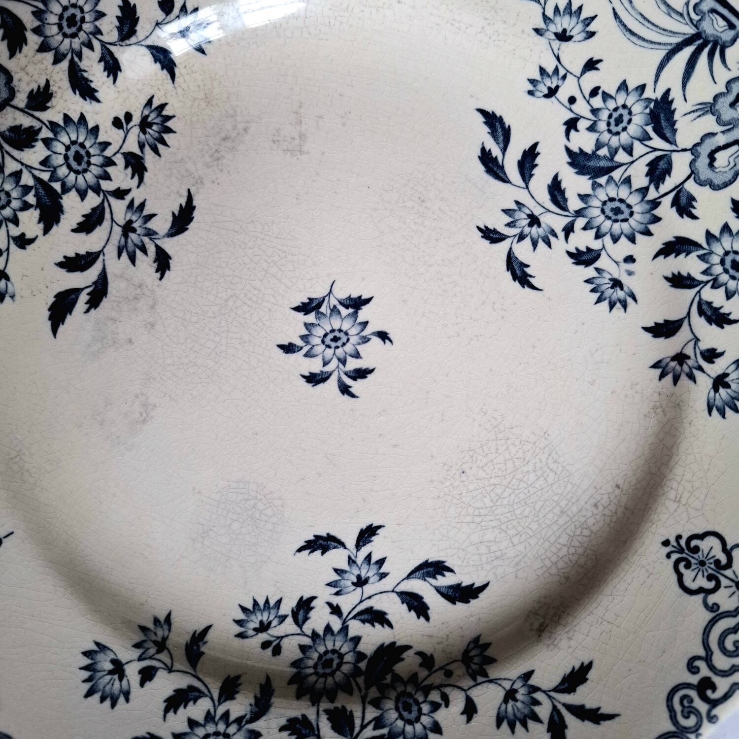 Old mismatched flat plates in iron earth earthenware accompanied by a dish