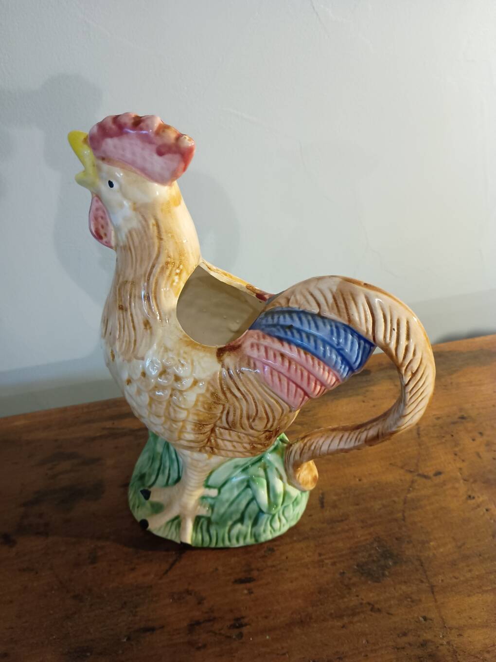 Vintage slipware jug in the shape of a rooster.