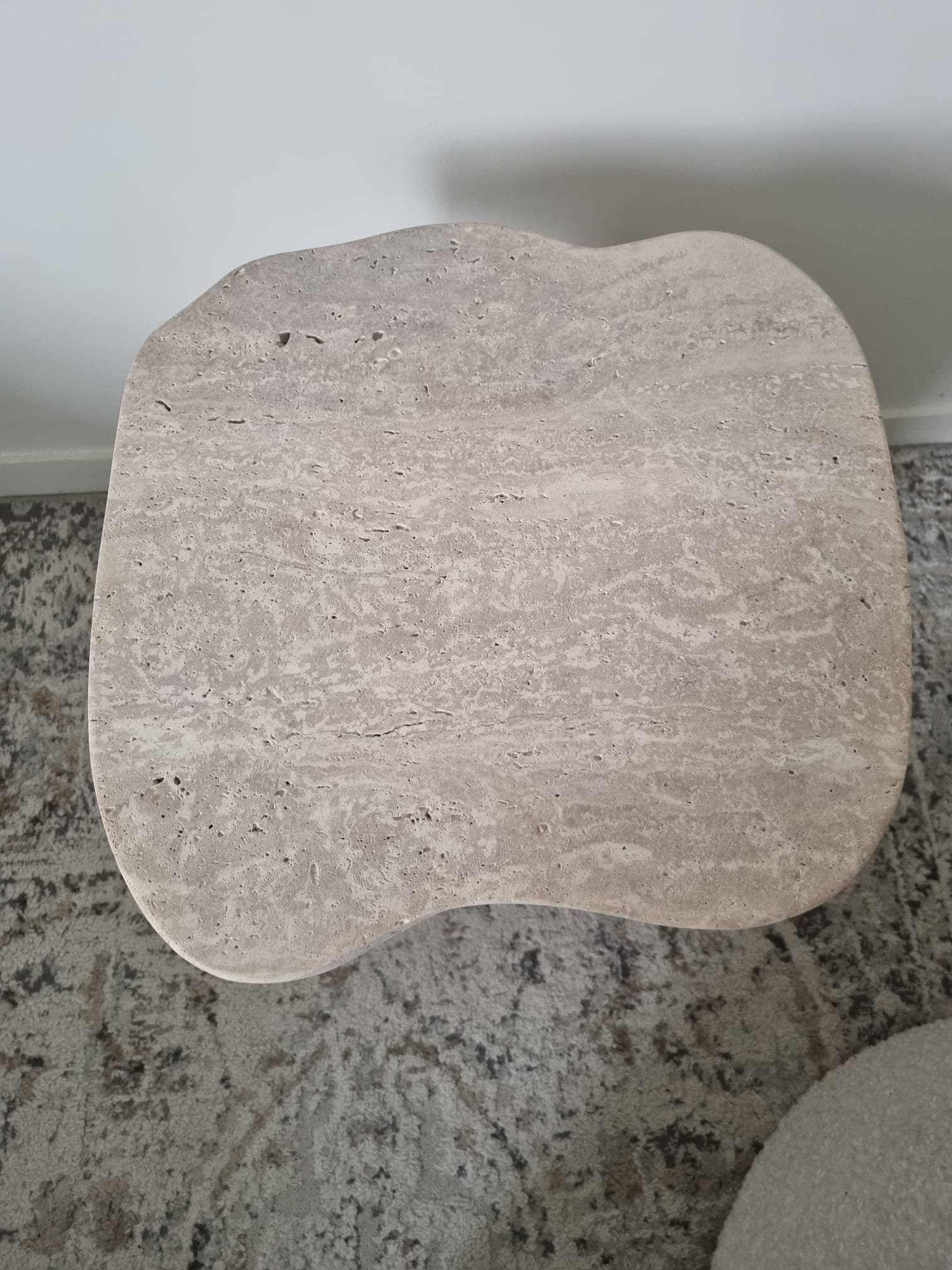 Alpha side table irregular natural travertine ribbed foot