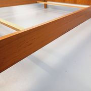Double bed vintage modernist in teak and black metal from the 1960s with bedside tables.