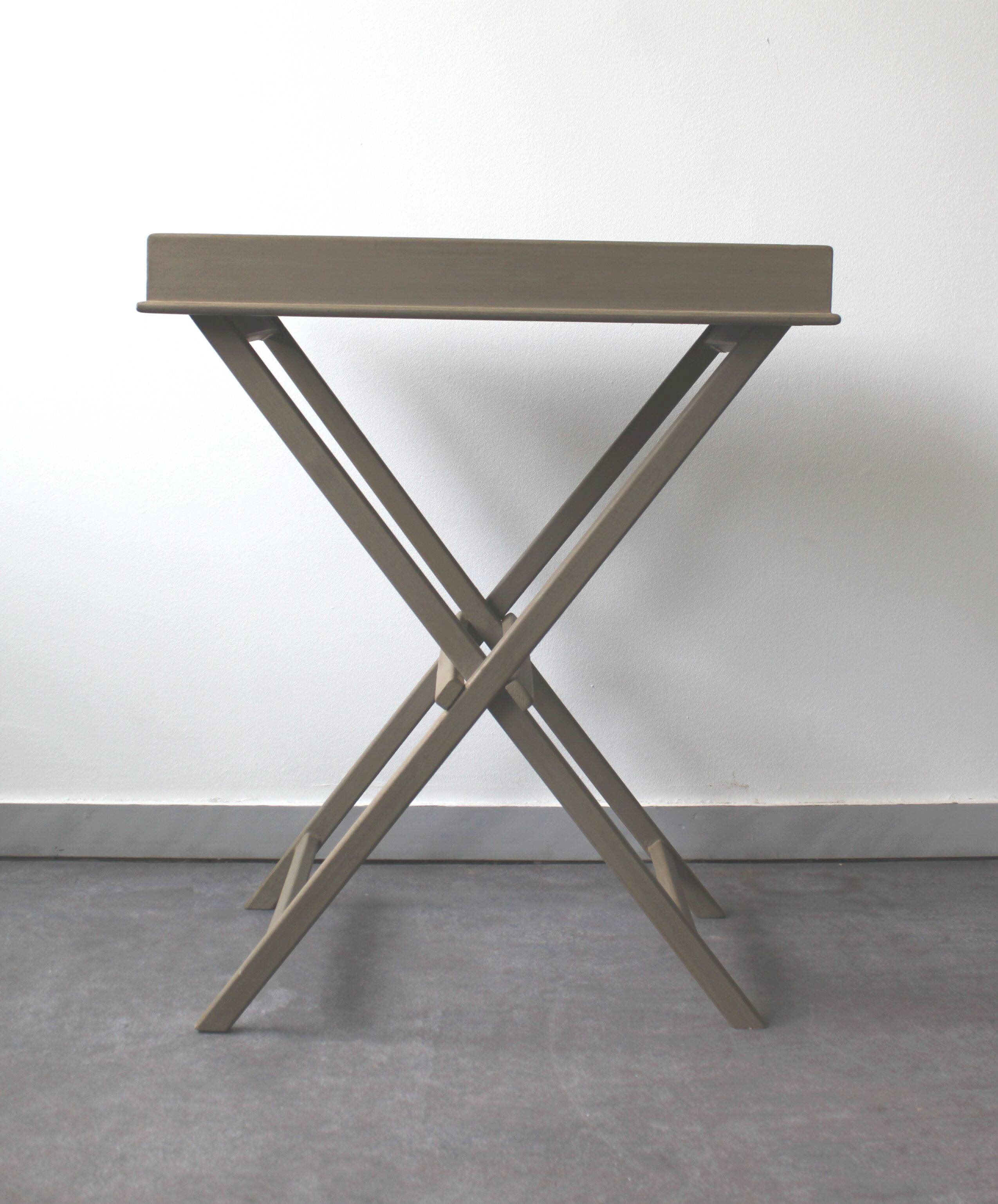 Folding and removable service tray in taupe-painted wood.