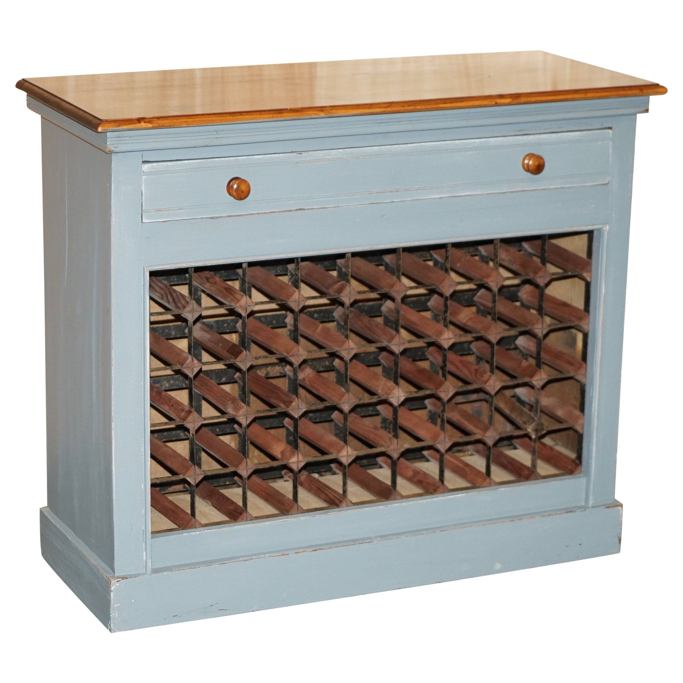 Vintage wooden furniture for 45 wine bottles with a drawer.
