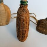 Trio of woven wicker bottles