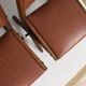 Pair of brutalist style chairs, in wood and leather.