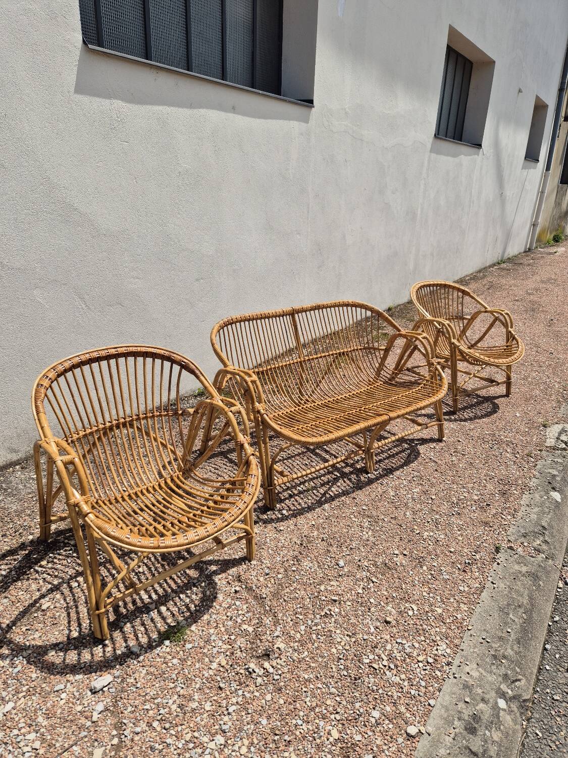 Rattan lounge with two armchairs and a vintage 1950s bench.