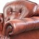 Cowhide chesterfield armchair in a warm brown colour with decorative nails
