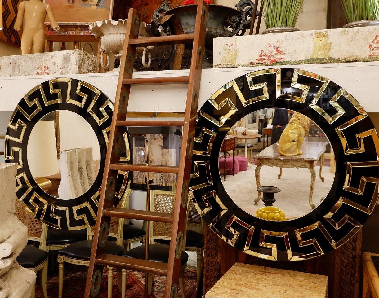 Pair of black and gold glass mirrors